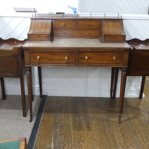 604 - An Edwardian Carlton House type Desk, the top with three quarter brass gallery, above hinged covers ... 