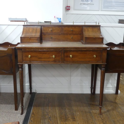 604 - An Edwardian Carlton House type Desk, the top with three quarter brass gallery, above hinged covers ... 