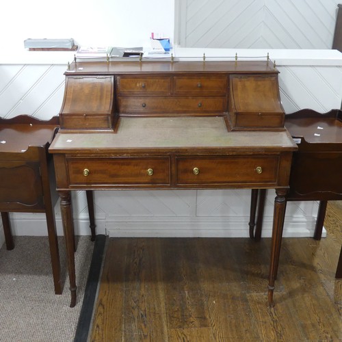 604 - An Edwardian Carlton House type Desk, the top with three quarter brass gallery, above hinged covers ... 