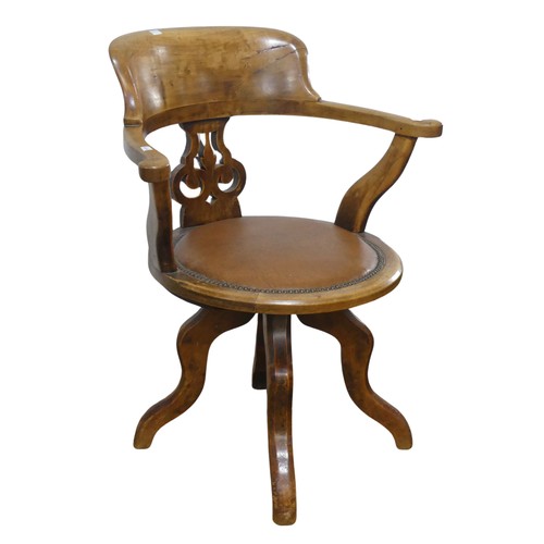 642 - An early 20th century mahogany swivel captains desk Chair, the shaped headrest over circular upholst... 