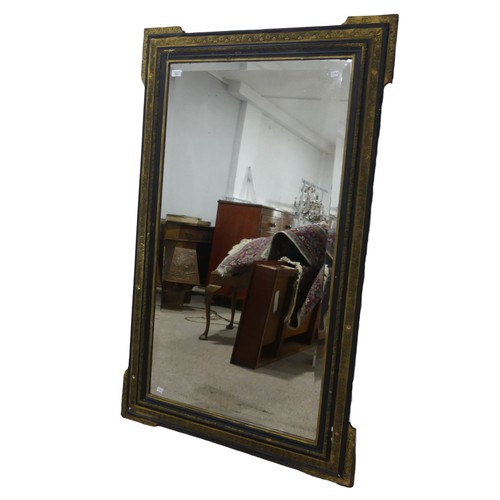 621 - A large antique 19th century style ebonised and gilt painted wall Mirror, the frame with carved gilt... 