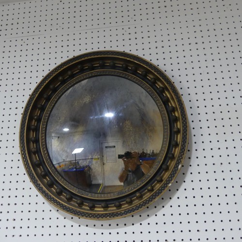 647 - A 19th century Regency style circular convex wall Mirror, the moulded frame applied with carvings an... 