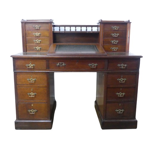 655 - A Victorian mahogany Dickens Desk, the top with shelf and gallery flanked by wellington style drawer... 