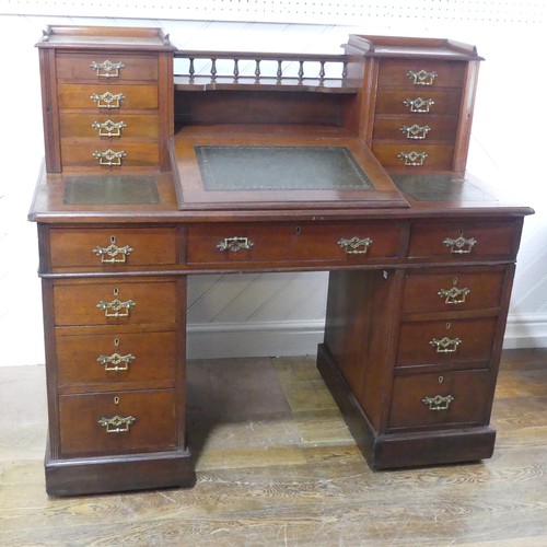 655 - A Victorian mahogany Dickens Desk, the top with shelf and gallery flanked by wellington style drawer... 