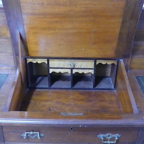 655 - A Victorian mahogany Dickens Desk, the top with shelf and gallery flanked by wellington style drawer... 