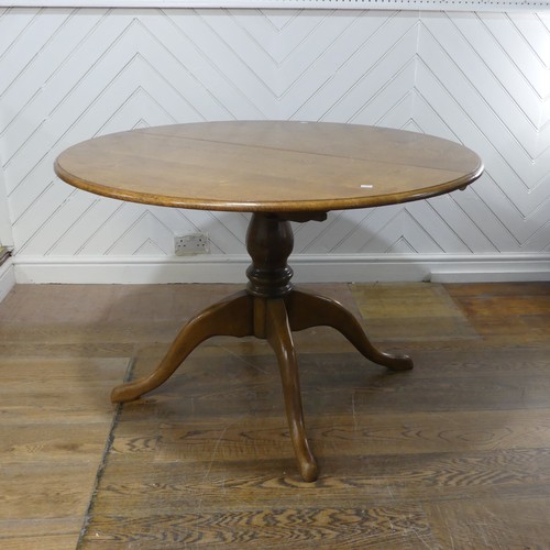 659 - A 20th century oak extending dining Table, with one additional leaf, circular top raised on central ... 