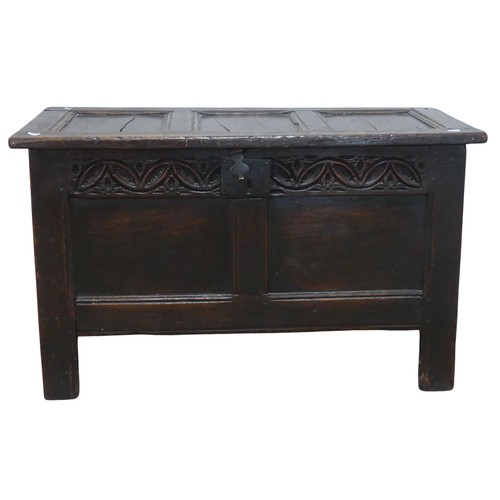 684 - An 18th century oak Coffer, of small proportions, the paneled top with pin hinges, above carved frie... 