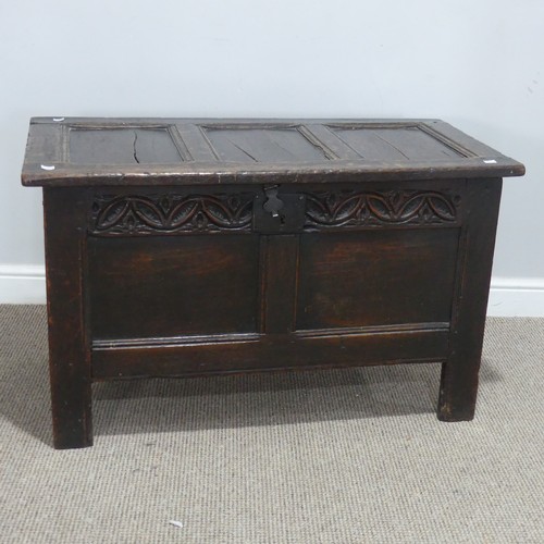 684 - An 18th century oak Coffer, of small proportions, the paneled top with pin hinges, above carved frie... 