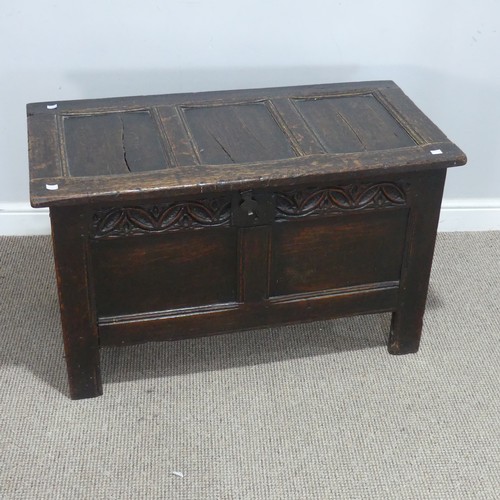 684 - An 18th century oak Coffer, of small proportions, the paneled top with pin hinges, above carved frie... 