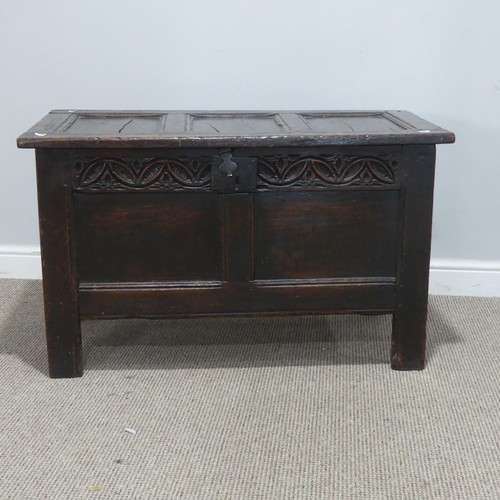 684 - An 18th century oak Coffer, of small proportions, the paneled top with pin hinges, above carved frie... 