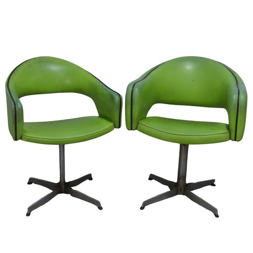 687 - A near pair of Retro mid-20th century swivel barbers Chairs, upholstered in green leatherette and ra... 