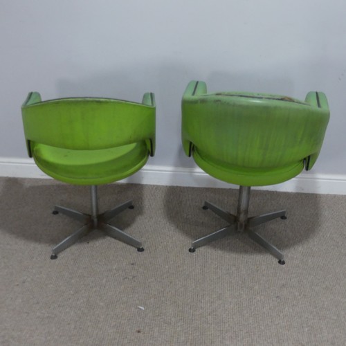 687 - A near pair of Retro mid-20th century swivel barbers Chairs, upholstered in green leatherette and ra... 