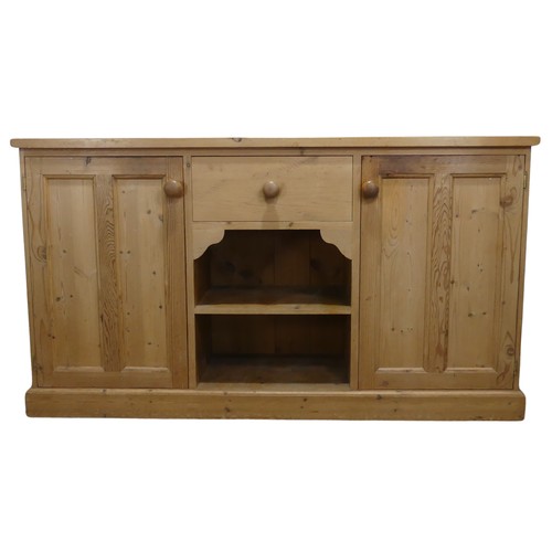 690 - A contemporary pine Sideboard, the rectangular top over central drawer and two shelves, flanked by c... 