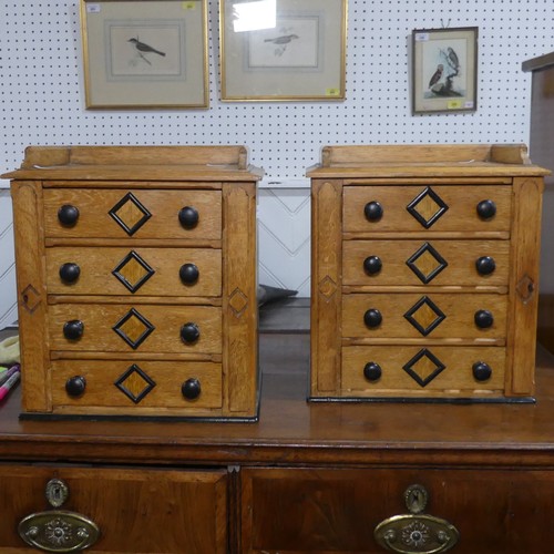 685 - A pair of small oak specimen Cabinets, each with four drawers mounted with turned ebonised handles, ... 