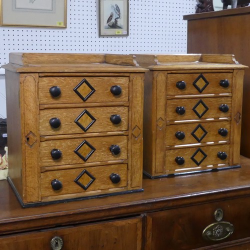 685 - A pair of small oak specimen Cabinets, each with four drawers mounted with turned ebonised handles, ... 