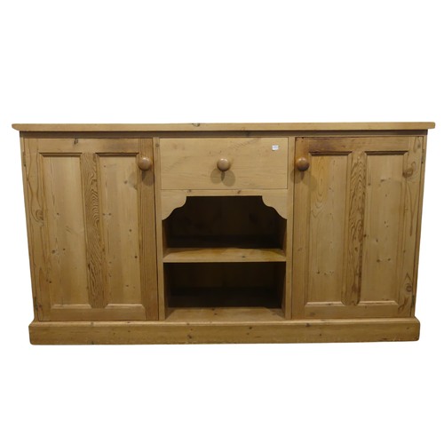 690 - A contemporary pine Sideboard, the rectangular top over central drawer and two shelves, flanked by c... 