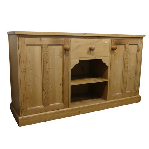 690 - A contemporary pine Sideboard, the rectangular top over central drawer and two shelves, flanked by c... 