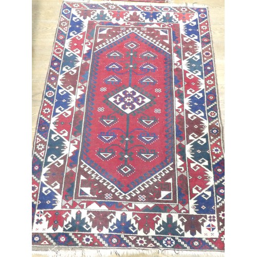 702 - Tribal Rugs: a Kazak rug, blue, red and cream geometric design, 100% wool, fringes and pile slightly... 