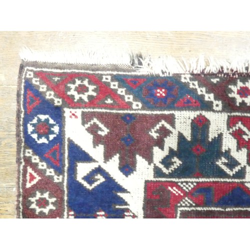 702 - Tribal Rugs: a Kazak rug, blue, red and cream geometric design, 100% wool, fringes and pile slightly... 