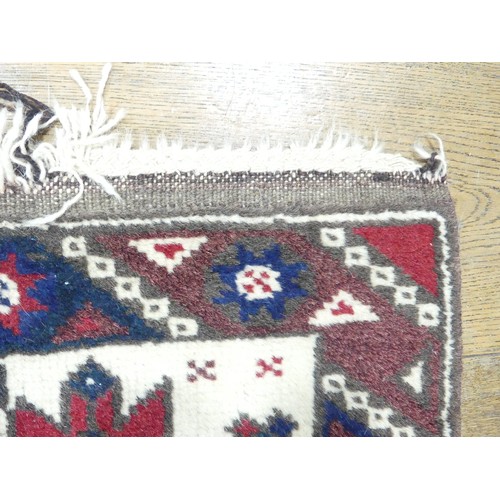 702 - Tribal Rugs: a Kazak rug, blue, red and cream geometric design, 100% wool, fringes and pile slightly... 