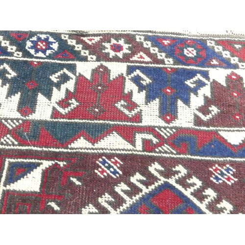 702 - Tribal Rugs: a Kazak rug, blue, red and cream geometric design, 100% wool, fringes and pile slightly... 