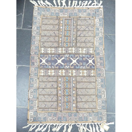 703 - Tribal Rugs: a buff ground Bokhara rug, wool pile on a cotton base, needs cleaning otherwise in good... 