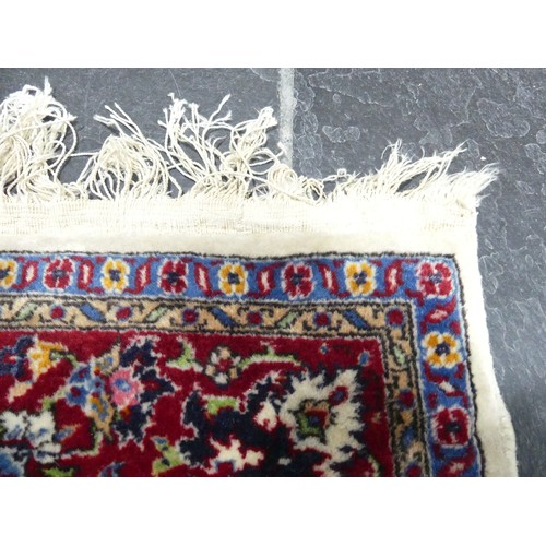 704 - Tribal Rugs; a Persian Isfahan rug, finely knotted wool pile on cotton base, cream ground within a r... 