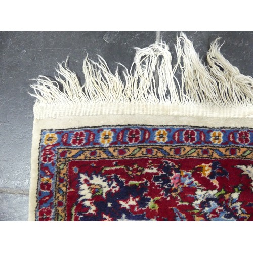 704 - Tribal Rugs; a Persian Isfahan rug, finely knotted wool pile on cotton base, cream ground within a r... 