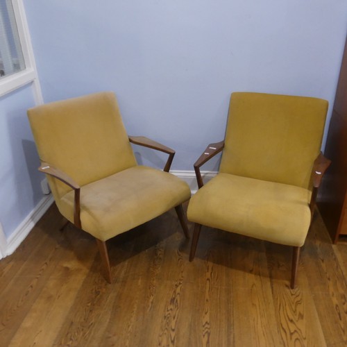 676 - A pair of mid-20th century teak G-plan easy Armchairs, probably Ib Kofod Larsen for G-Plan for the '... 