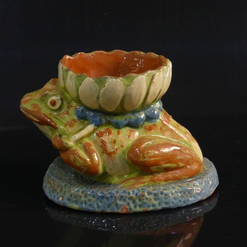 77 - A C. H. Brannam pottery Candle holder modelled as a Frog, in forward leaning pose with leg clutching... 