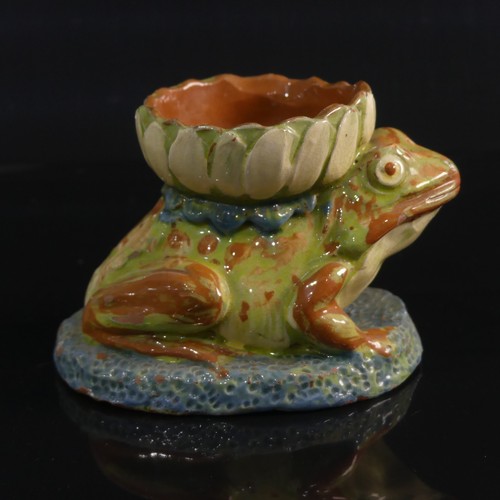 77 - A C. H. Brannam pottery Candle holder modelled as a Frog, in forward leaning pose with leg clutching... 