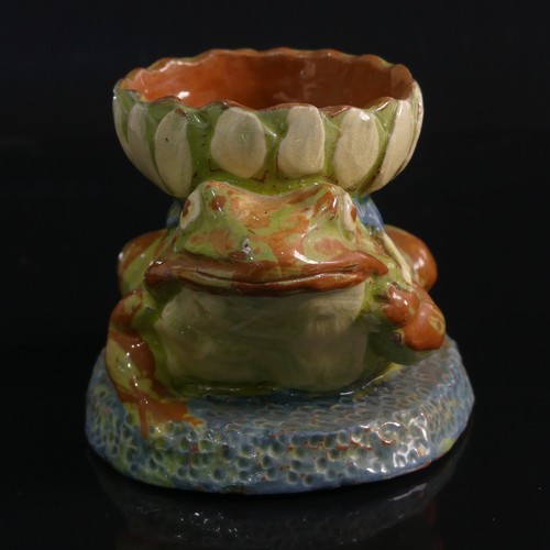 77 - A C. H. Brannam pottery Candle holder modelled as a Frog, in forward leaning pose with leg clutching... 