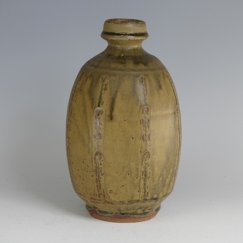 82 - Mike Dodd (b. 1943) a faceted stoneware Vase, in thick green ash glaze, with bottle neck, impressed ... 