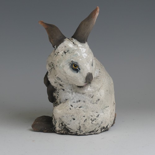 83 - Keza Rudge (British 20th century) a studio pottery Raku Rabbit, modelled in seated position with tur... 