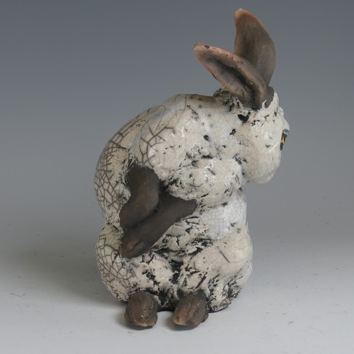 83 - Keza Rudge (British 20th century) a studio pottery Raku Rabbit, modelled in seated position with tur... 