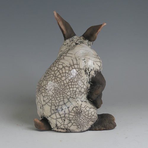 83 - Keza Rudge (British 20th century) a studio pottery Raku Rabbit, modelled in seated position with tur... 