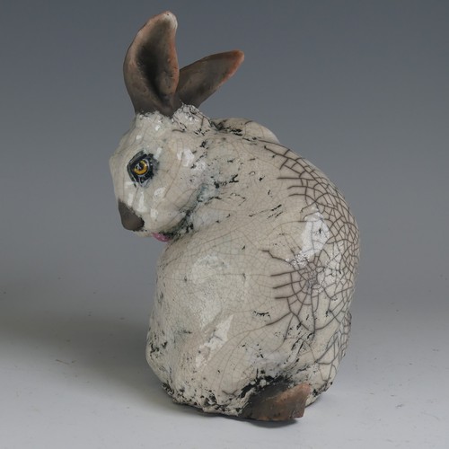 83 - Keza Rudge (British 20th century) a studio pottery Raku Rabbit, modelled in seated position with tur... 