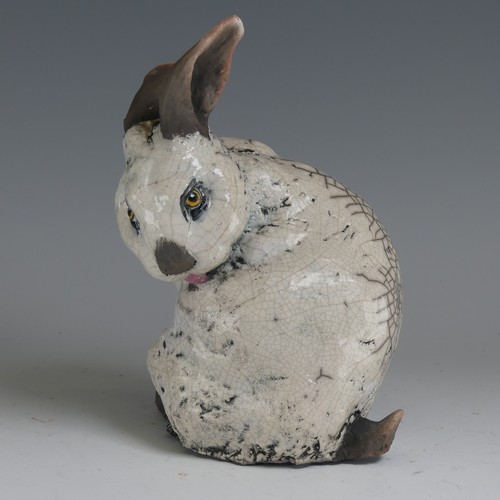 83 - Keza Rudge (British 20th century) a studio pottery Raku Rabbit, modelled in seated position with tur... 