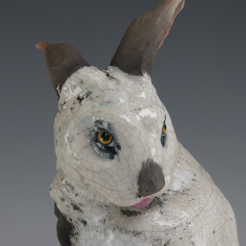 83 - Keza Rudge (British 20th century) a studio pottery Raku Rabbit, modelled in seated position with tur... 