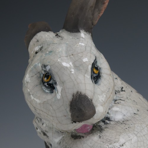 83 - Keza Rudge (British 20th century) a studio pottery Raku Rabbit, modelled in seated position with tur... 