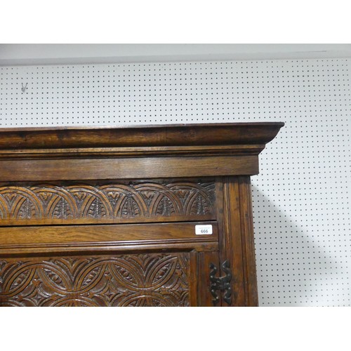 666 - A 17th century and later carved oak hall Cupboard, the carved and moulded cornice over two large pan... 