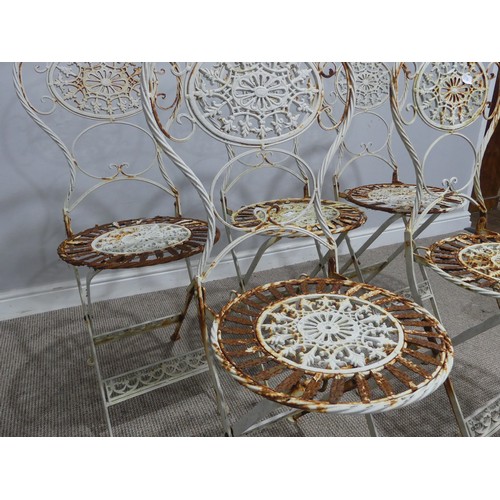 656 - A set of six Victorian white painted metal folding garden Chairs, weathered, with pierced decoration... 