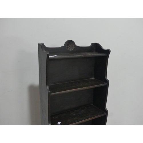 668 - A 20th century ebonised oak waterfall Bookcase, W 45.5 cm x H 113 cm x D 23 cm.