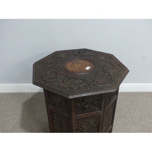 606 - An Anglo-Indian style carved occasional Table, with carved octagonal top supported on folding sides,... 