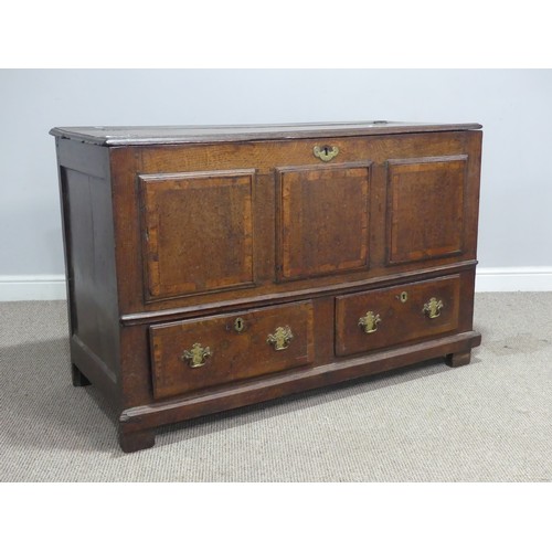 635 - An 18th century oak mule Chest, the hinged top over paneled sides and two drawers, raised on stump f... 