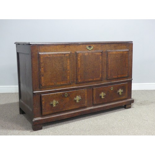 635 - An 18th century oak mule Chest, the hinged top over paneled sides and two drawers, raised on stump f... 