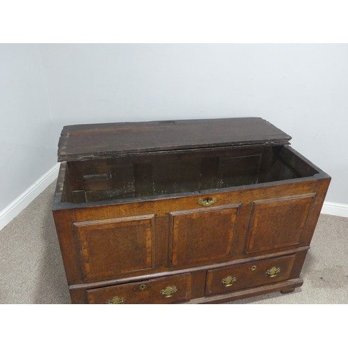 635 - An 18th century oak mule Chest, the hinged top over paneled sides and two drawers, raised on stump f... 