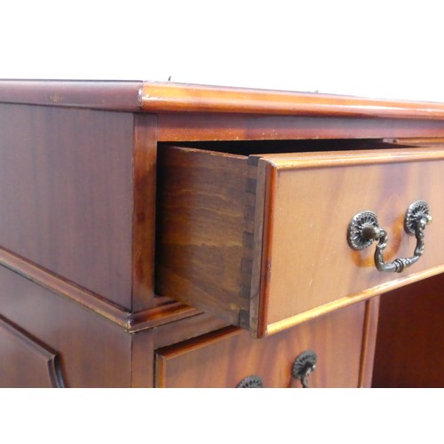 615 - A 20th century mahogany pedestal Desk, the three sectional top inset with leather skiver, above knee... 