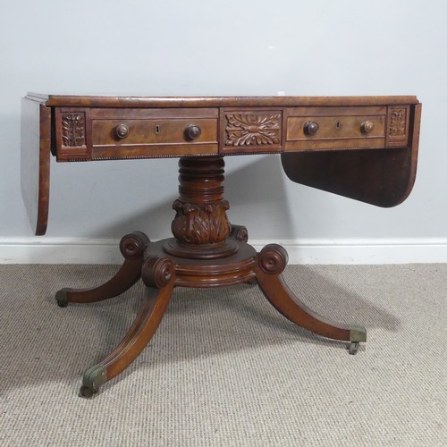 549 - A Regency mahogany and rosewood banded Sofa Table, raised on carved column and quadraform reeded sup... 