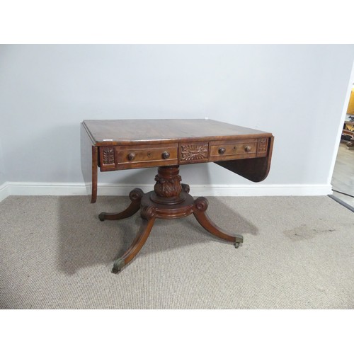 549 - A Regency mahogany and rosewood banded Sofa Table, raised on carved column and quadraform reeded sup... 